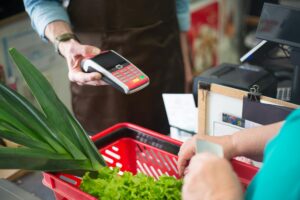 Why Major Supermarket Chains Are Replacing Self-Checkout With AI Cashiers Modern grocery store checkout area with multiple lanes and scanning equipment