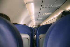 How Major Airlines Are Converting Cargo Space Into Premium Passenger Services Modern airplane cabin interior with rows of passenger seats and overhead compartments