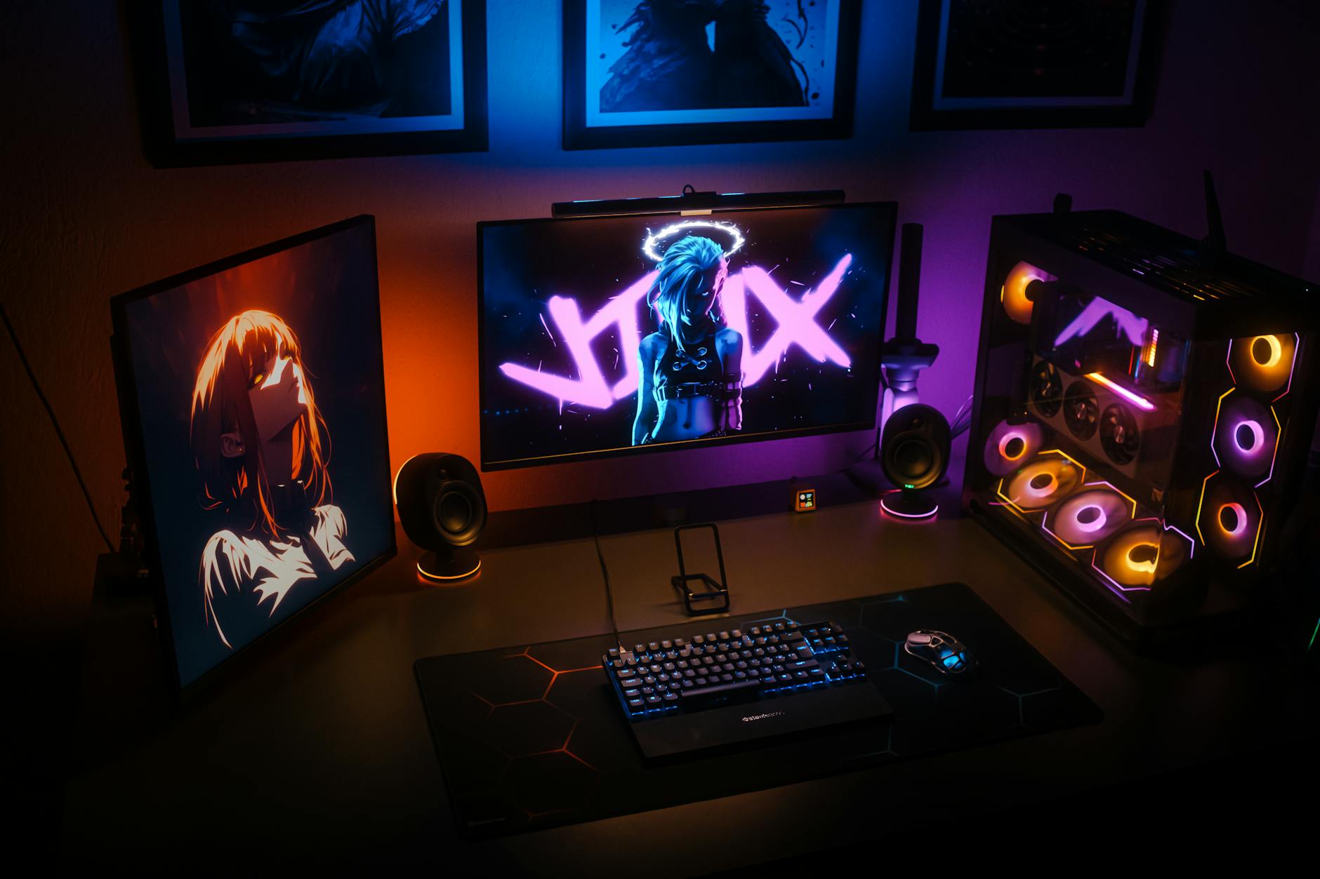 Modern gaming setup with RGB keyboard, mouse, and monitor displaying colorful lighting effects