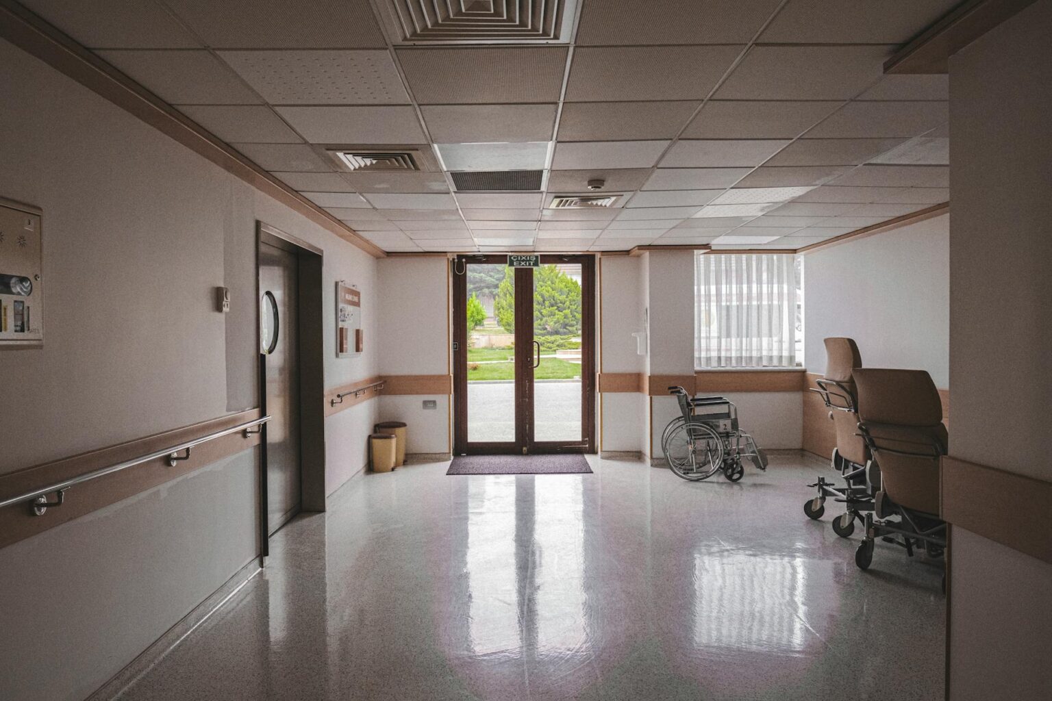 The Economic Impact of America’s Registered Nurse Shortage on Hospital Costs Empty hospital hallway with medical equipment and nursing station
