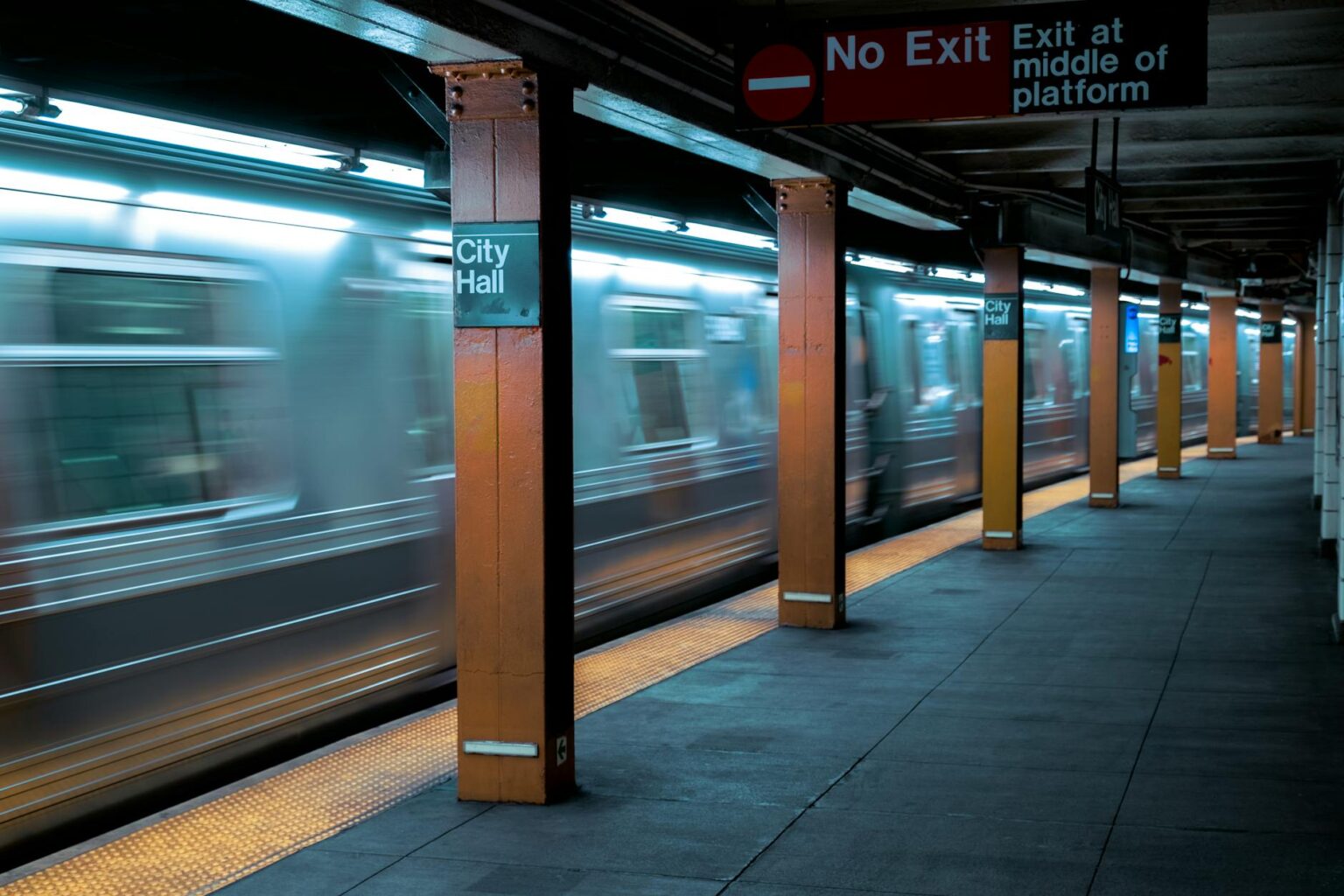 The Economic Impact of Corporate Return-to-Office Mandates on Urban Transit Busy subway platform with commuters waiting for trains during rush hour
