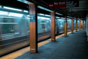 Busy subway platform with commuters waiting for trains during rush hour