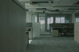 Empty office building with vacant floors and minimal lighting showing the impact of remote work on commercial real estate
