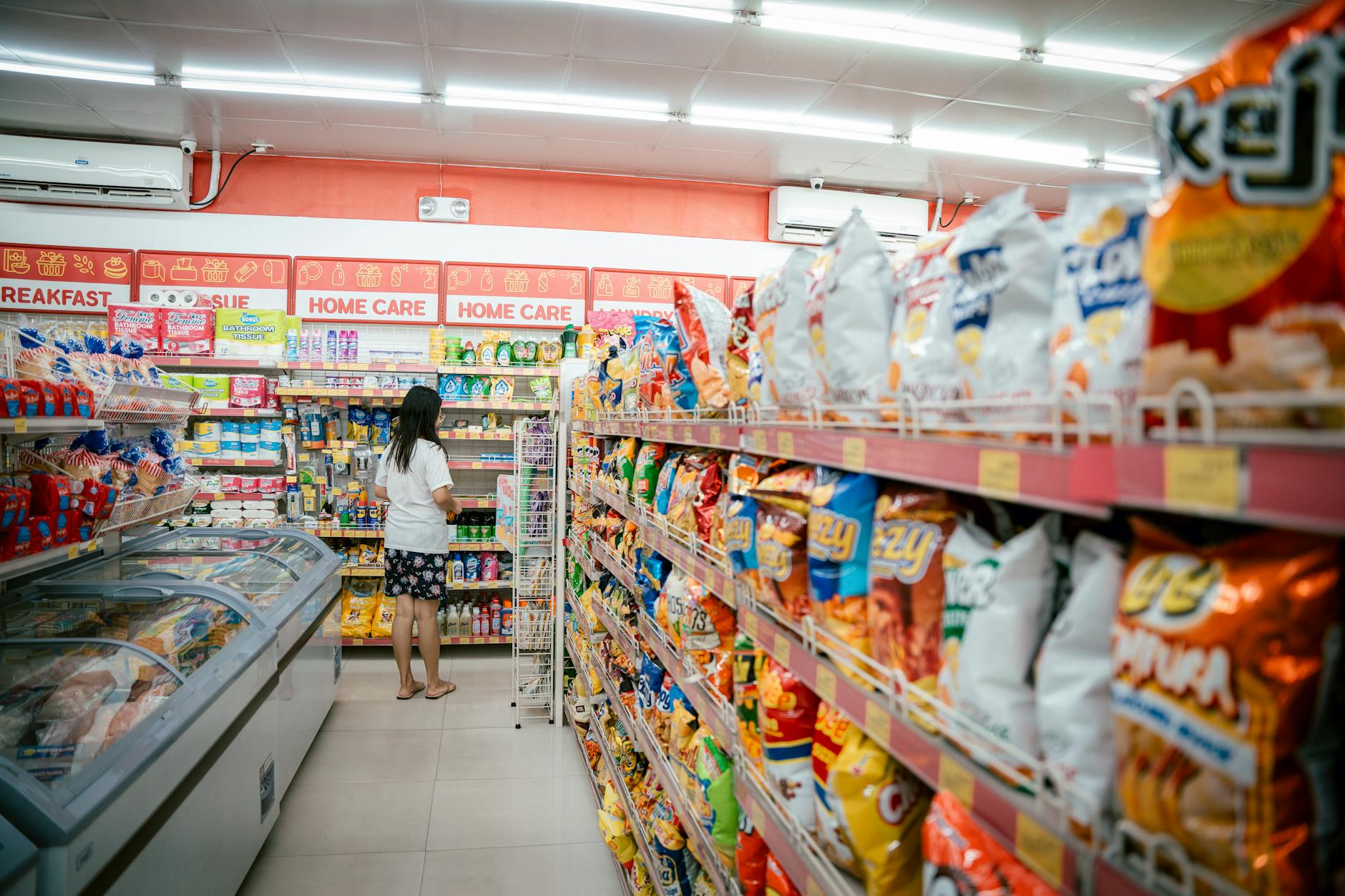 Modern grocery store aisle with shoppers and well-stocked shelves