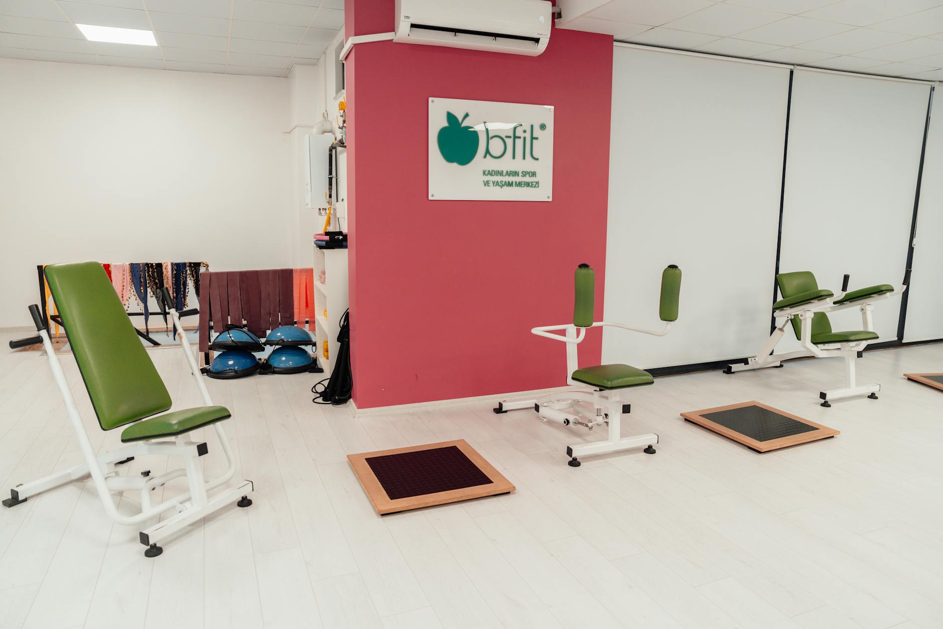 Modern corporate fitness center with exercise equipment and large windows