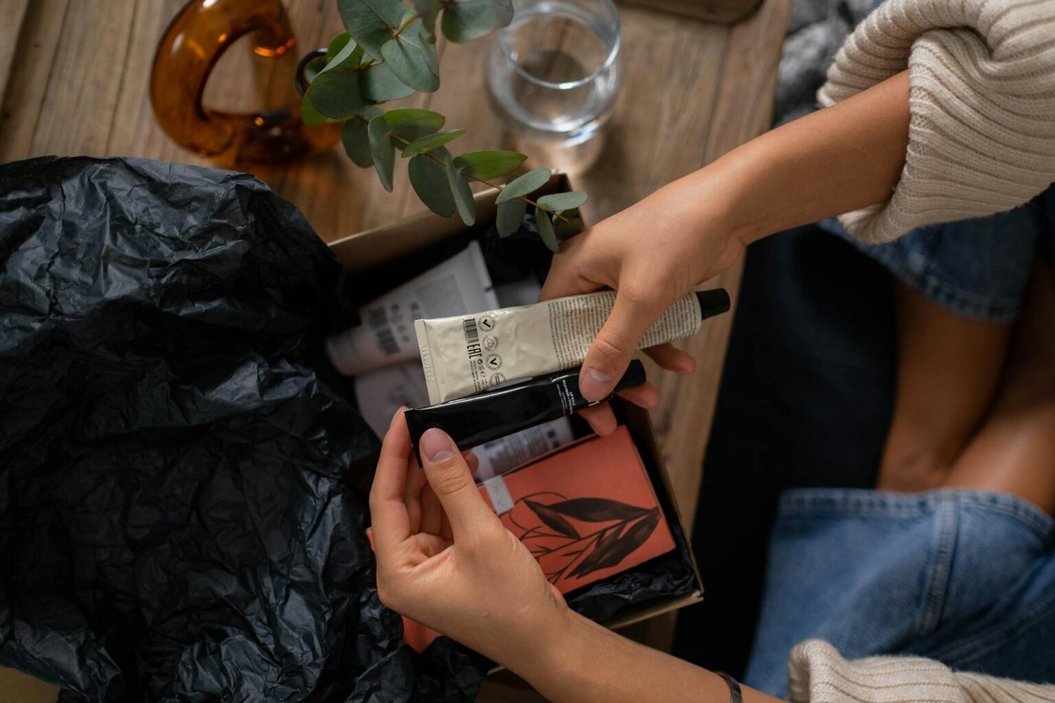 Colorful subscription boxes stacked on a table with various products displayed