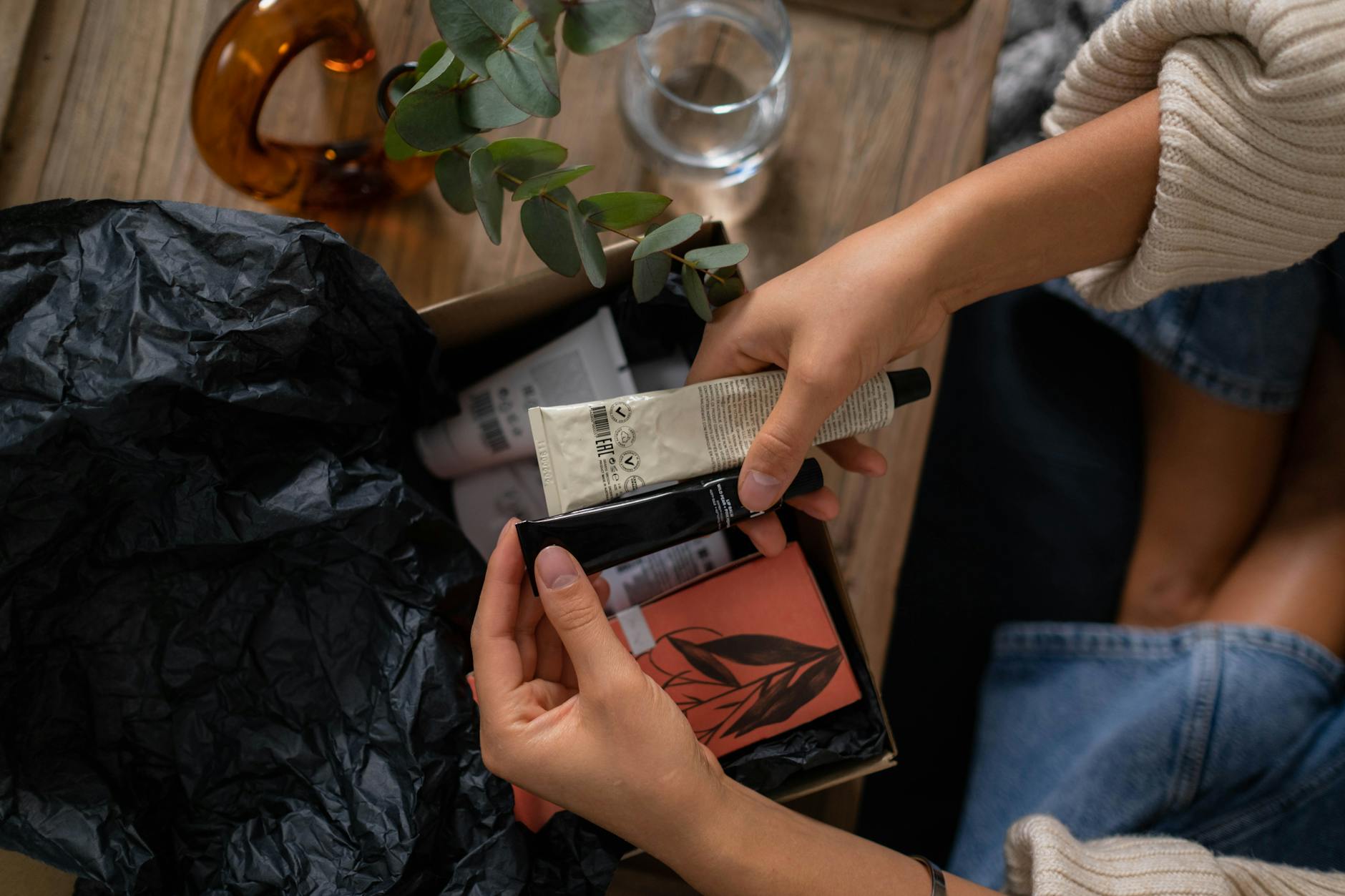 Colorful subscription boxes stacked on a table with various products displayed