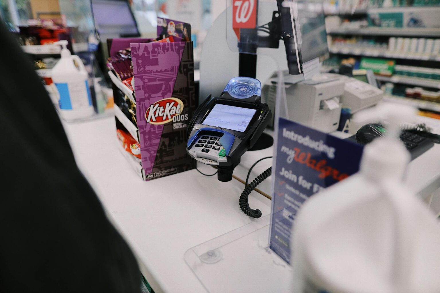 Modern retail checkout counter with self-service stations and traditional lanes