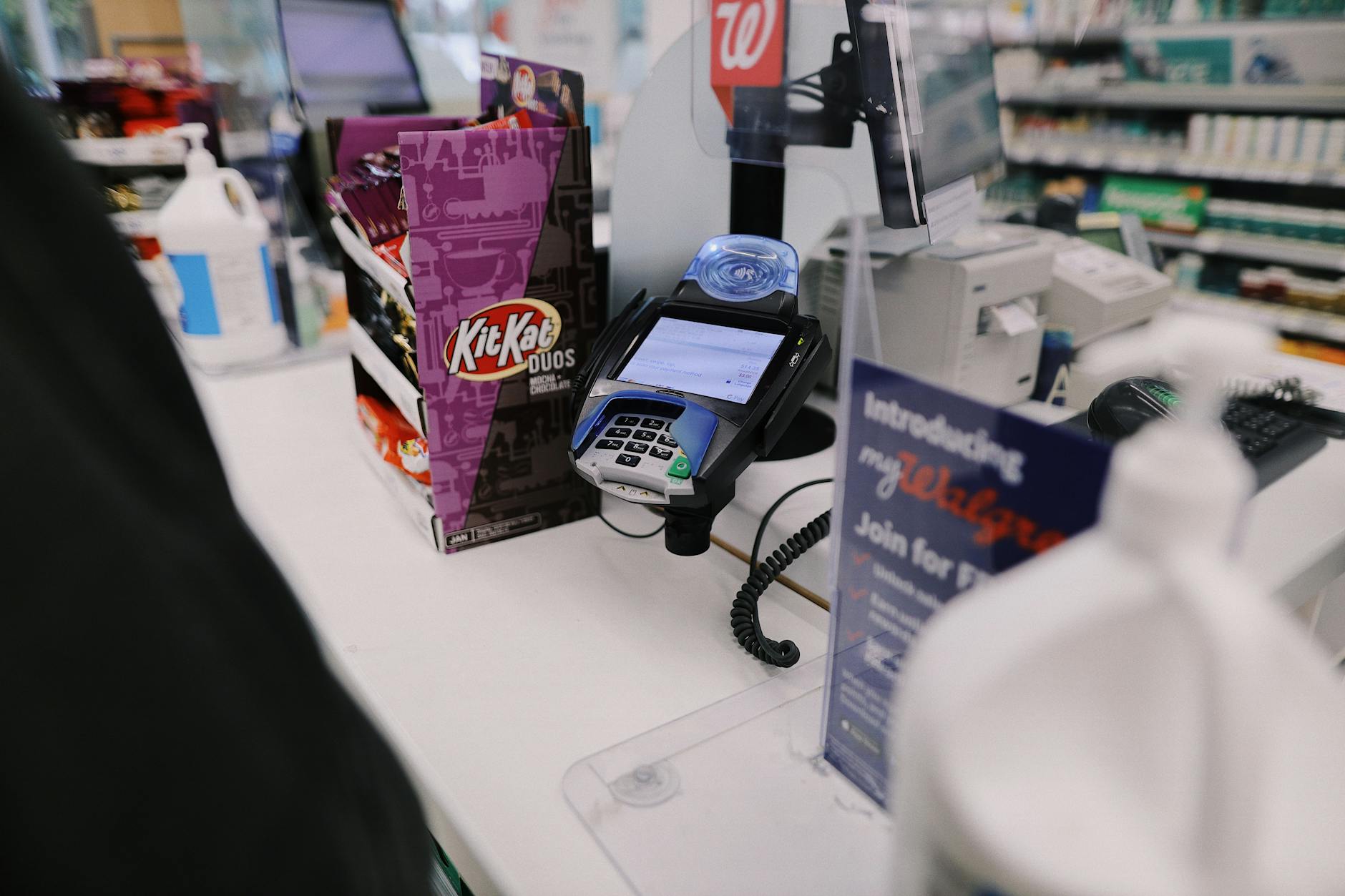 Modern retail checkout counter with self-service stations and traditional lanes