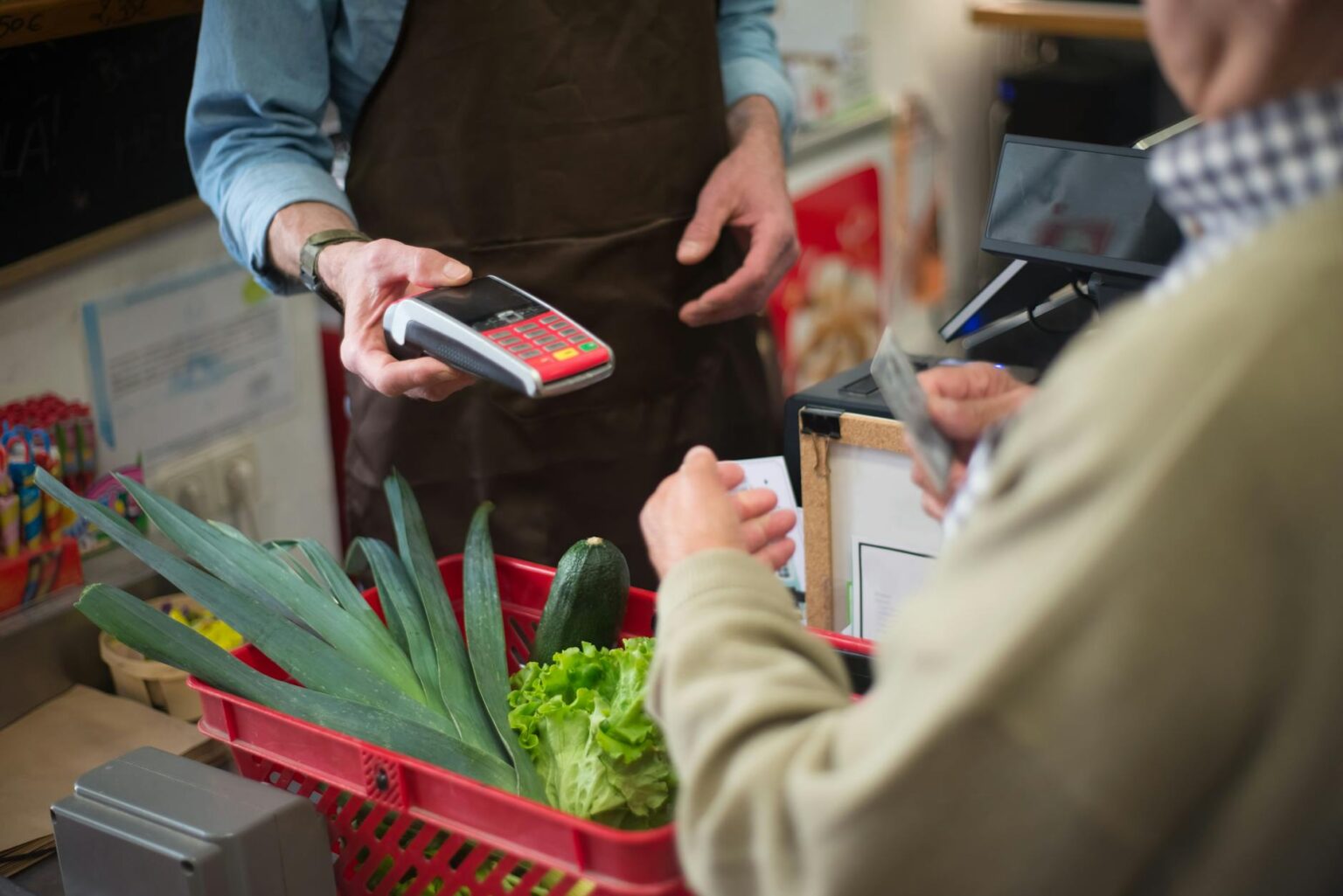 Modern grocery store checkout counter with digital scanner and payment terminal