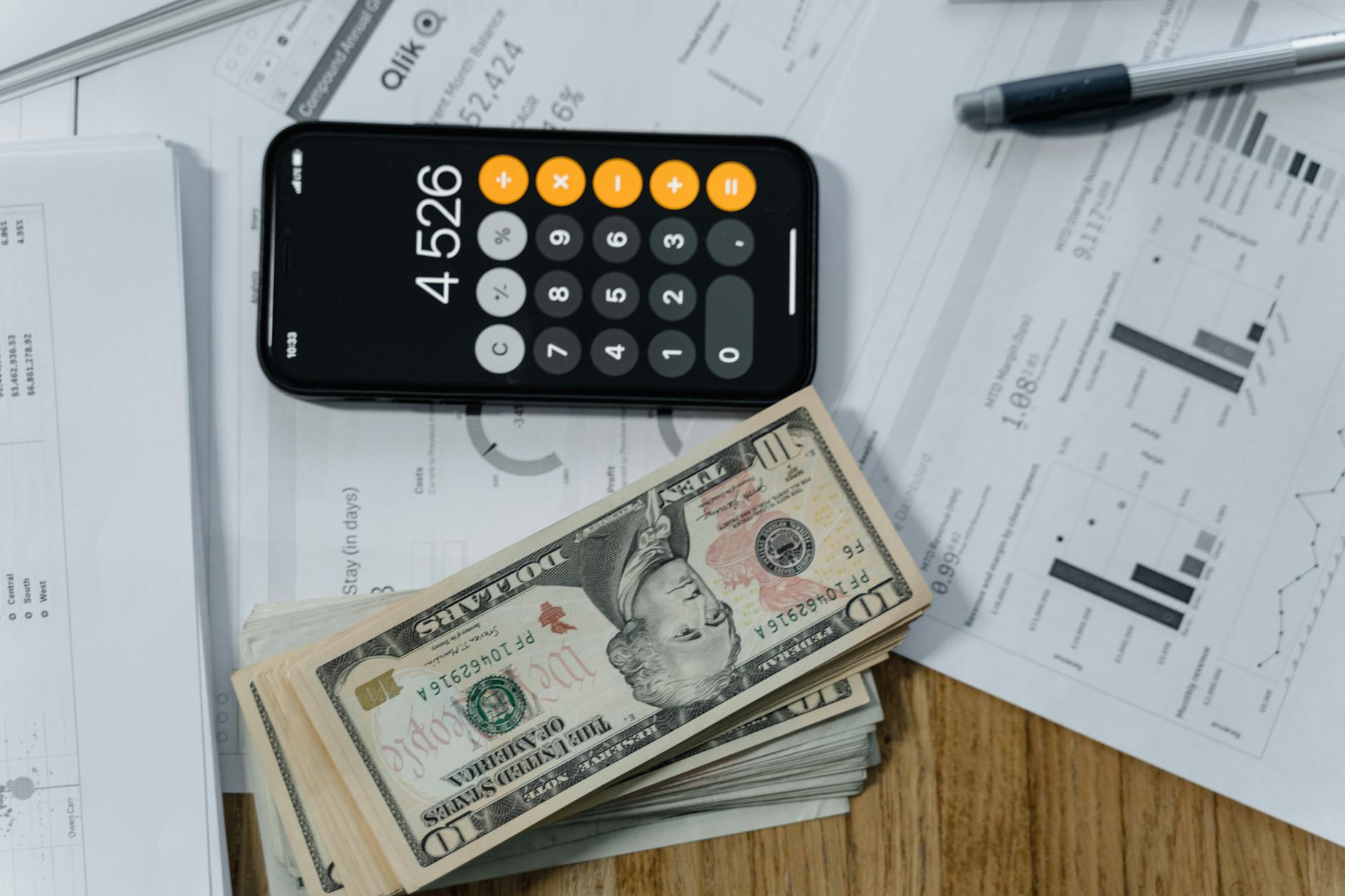 Calculator and money on desk representing financial planning calculations