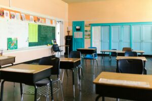 Empty classroom with desks and chairs arranged but no students or teacher present