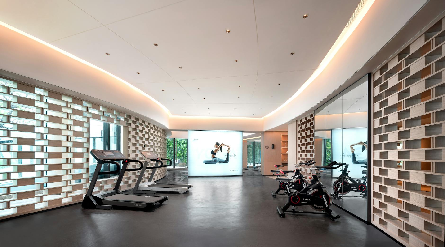 Modern corporate fitness facility with exercise equipment and bright lighting