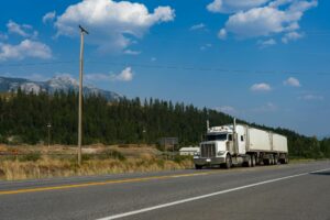 Large semi-truck driving on interstate highway representing America's transportation network