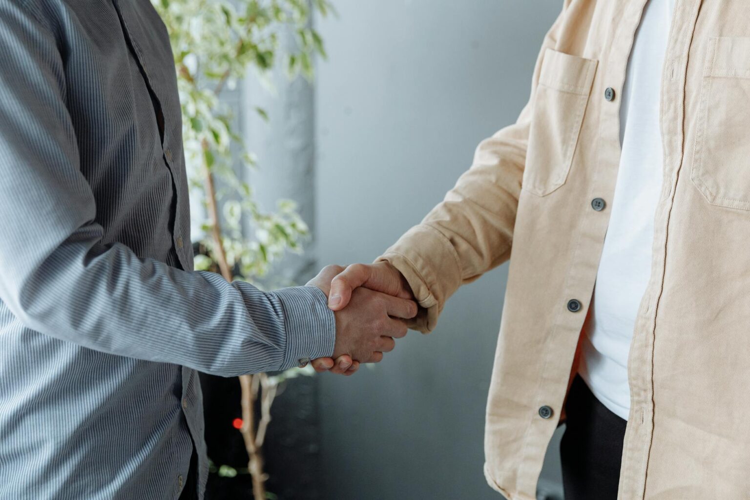 Business professionals shaking hands during partnership meeting