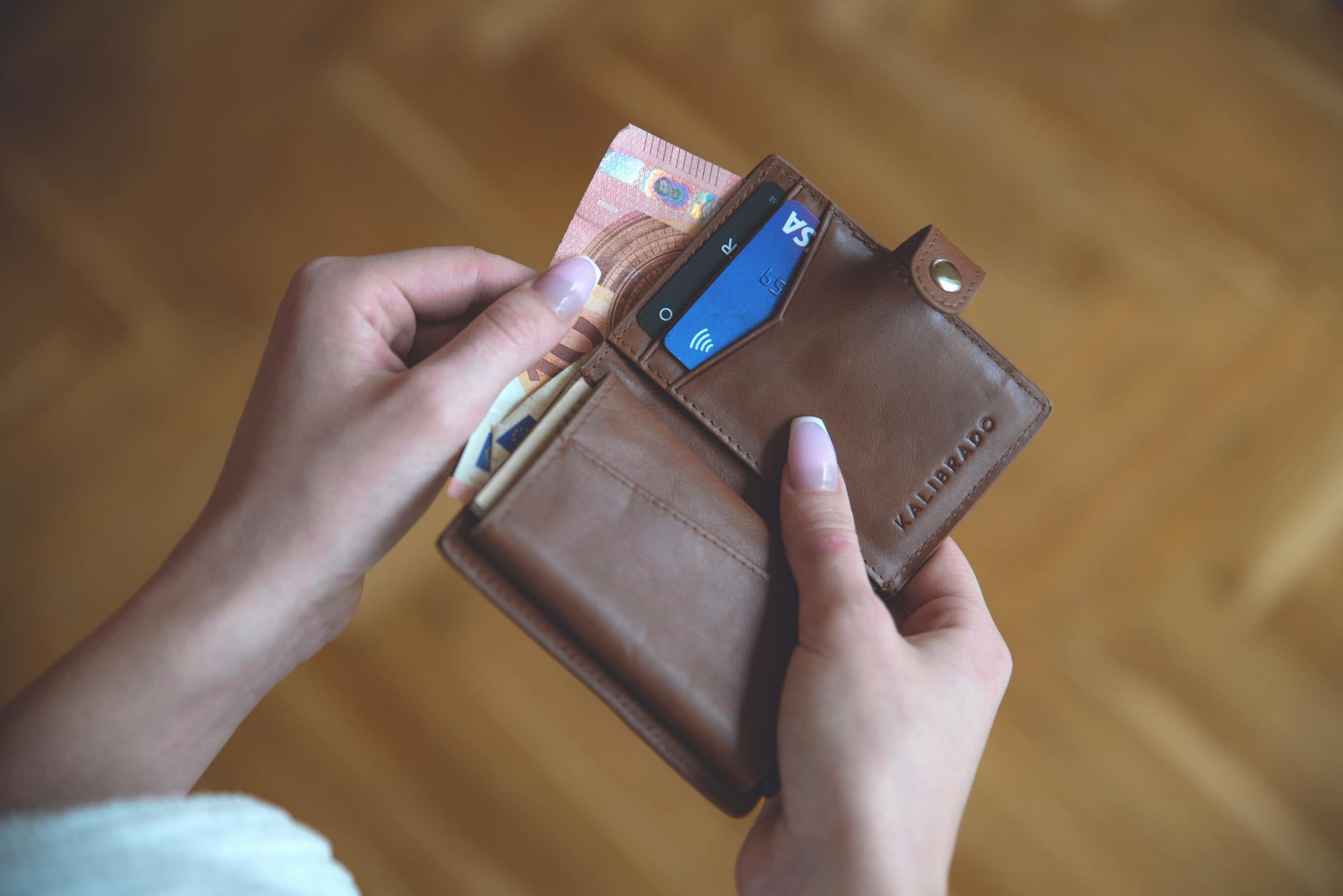 Multiple premium credit cards arranged in leather wallet showing travel rewards branding