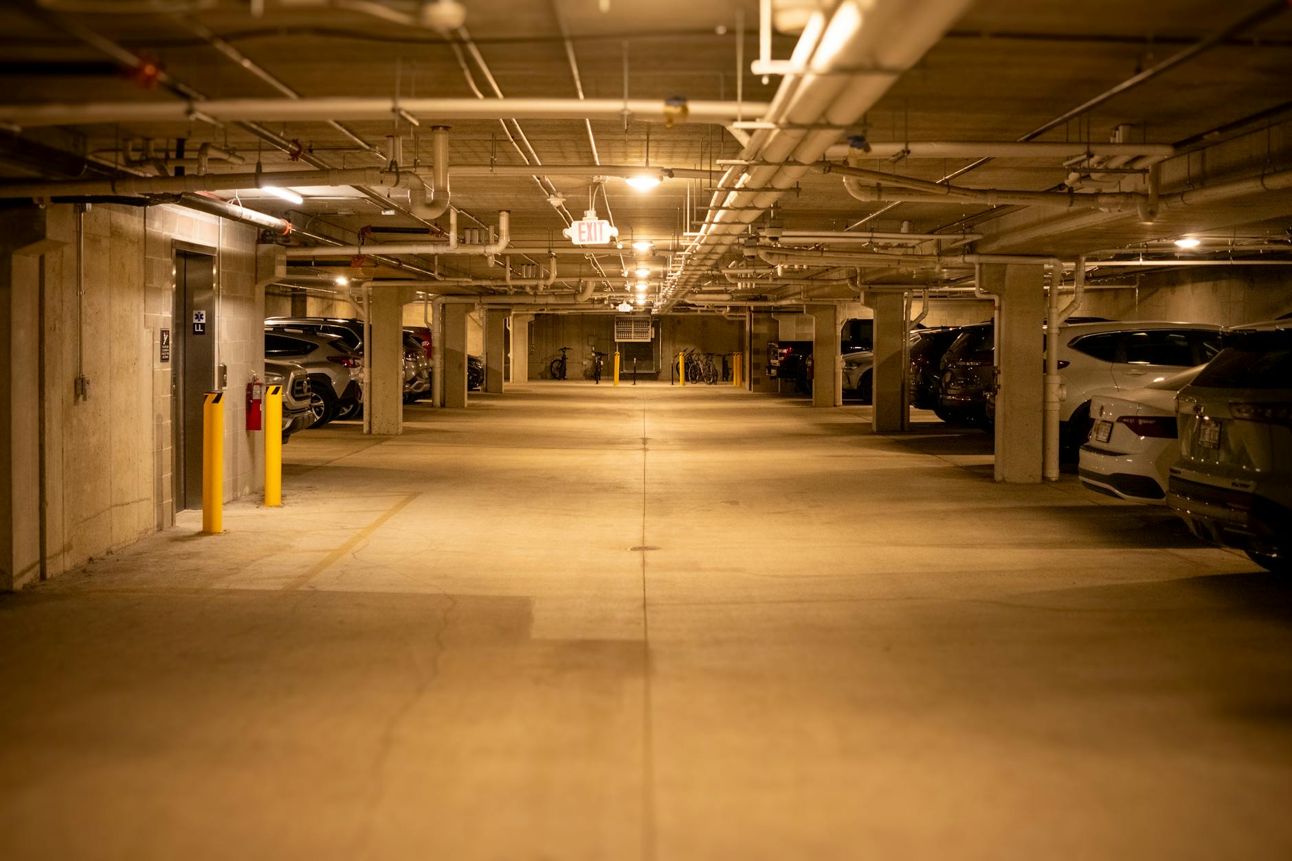 Multi-level parking garage interior with concrete structure and lighting