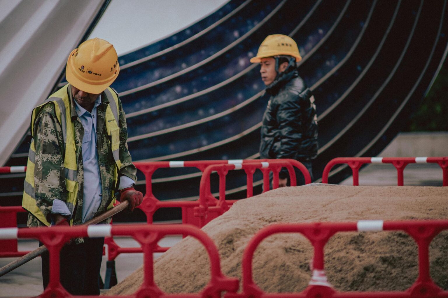 The Economic Impact of America’s Skilled Trade Worker Shortage Construction workers in hard hats and safety vests working on a building site