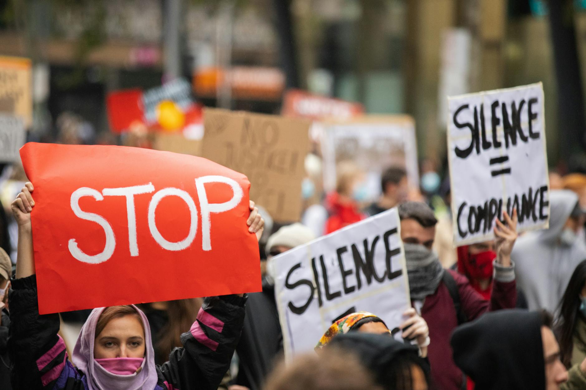 Group of people holding protest signs during demonstration