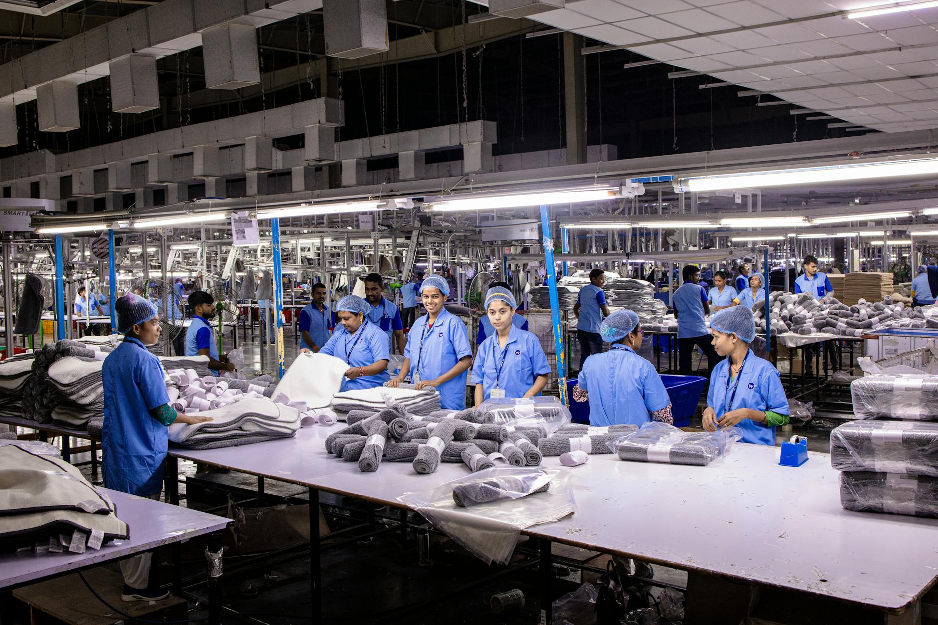 Manufacturing employees working efficiently in a modern industrial facility with machinery