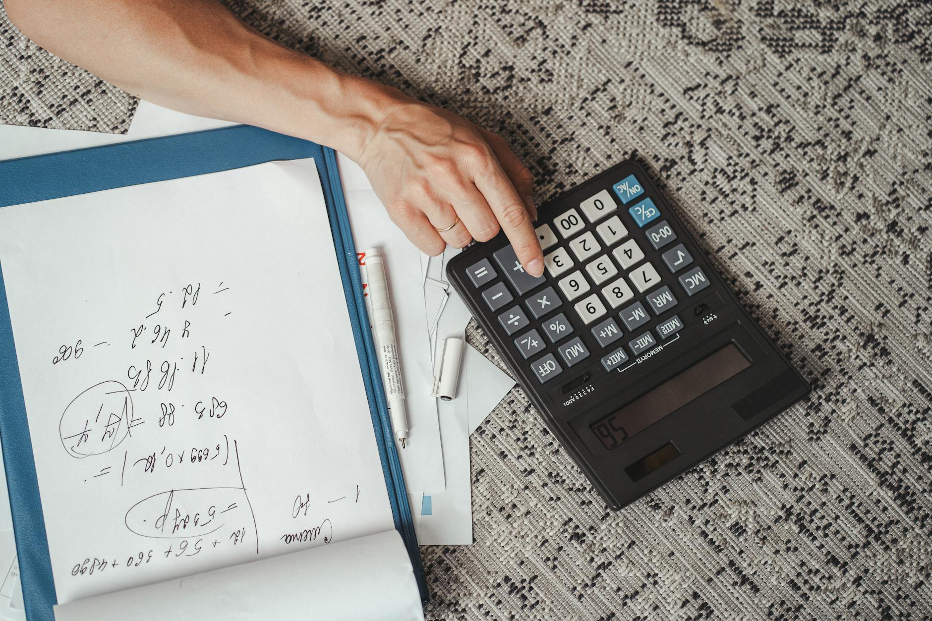 Calculator and financial documents on desk showing tax calculations
