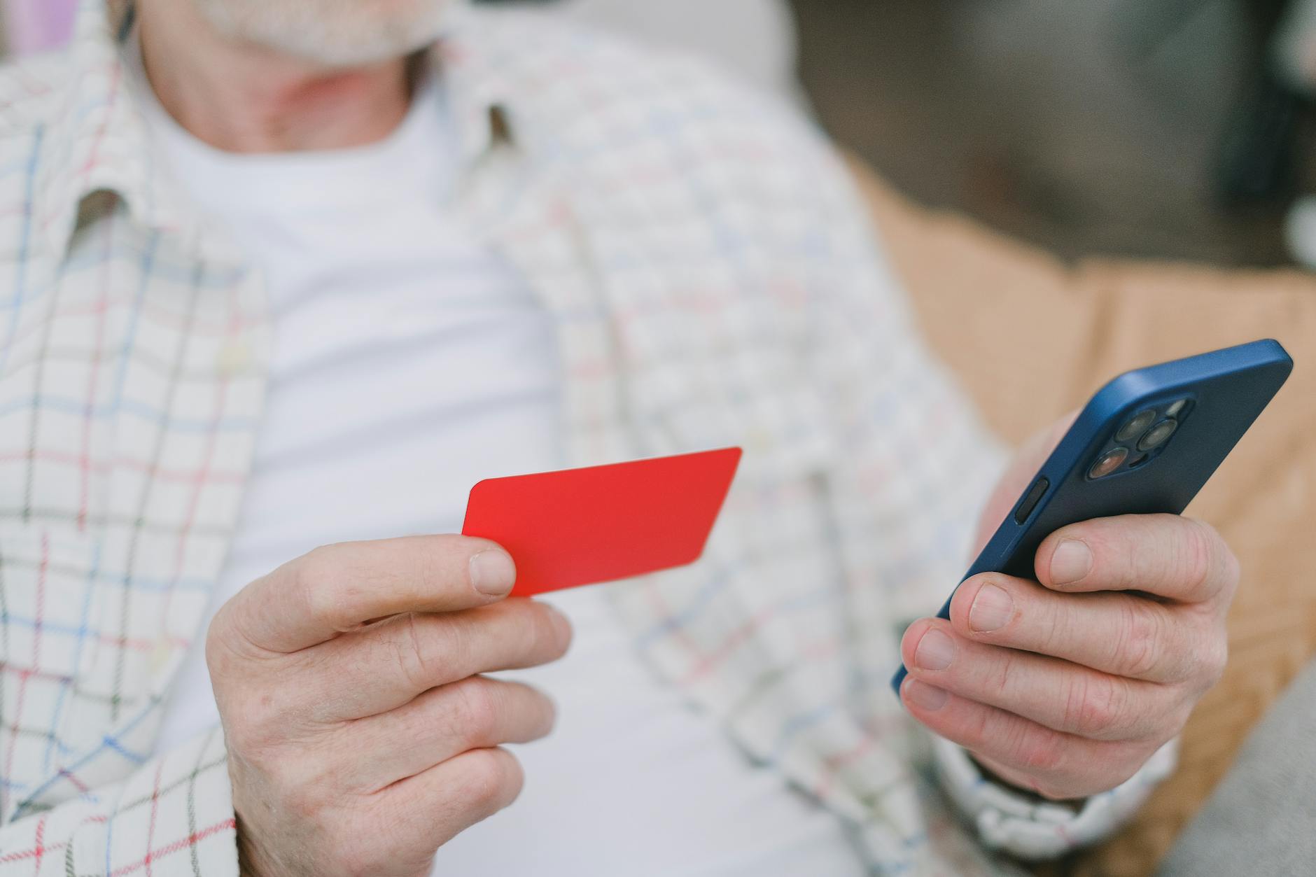 Person using smartphone to check banking app and manage finances