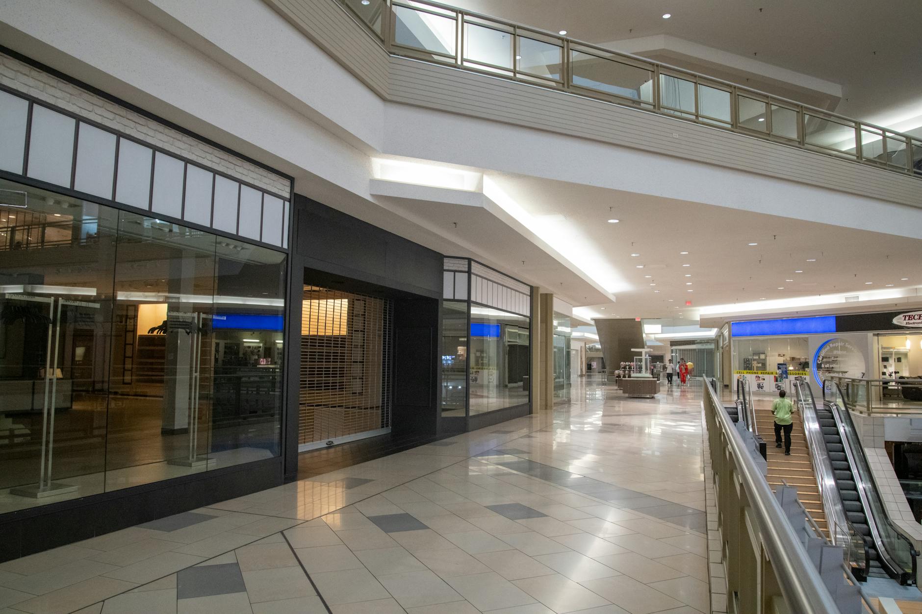Modern shopping mall interior with retail stores and display windows