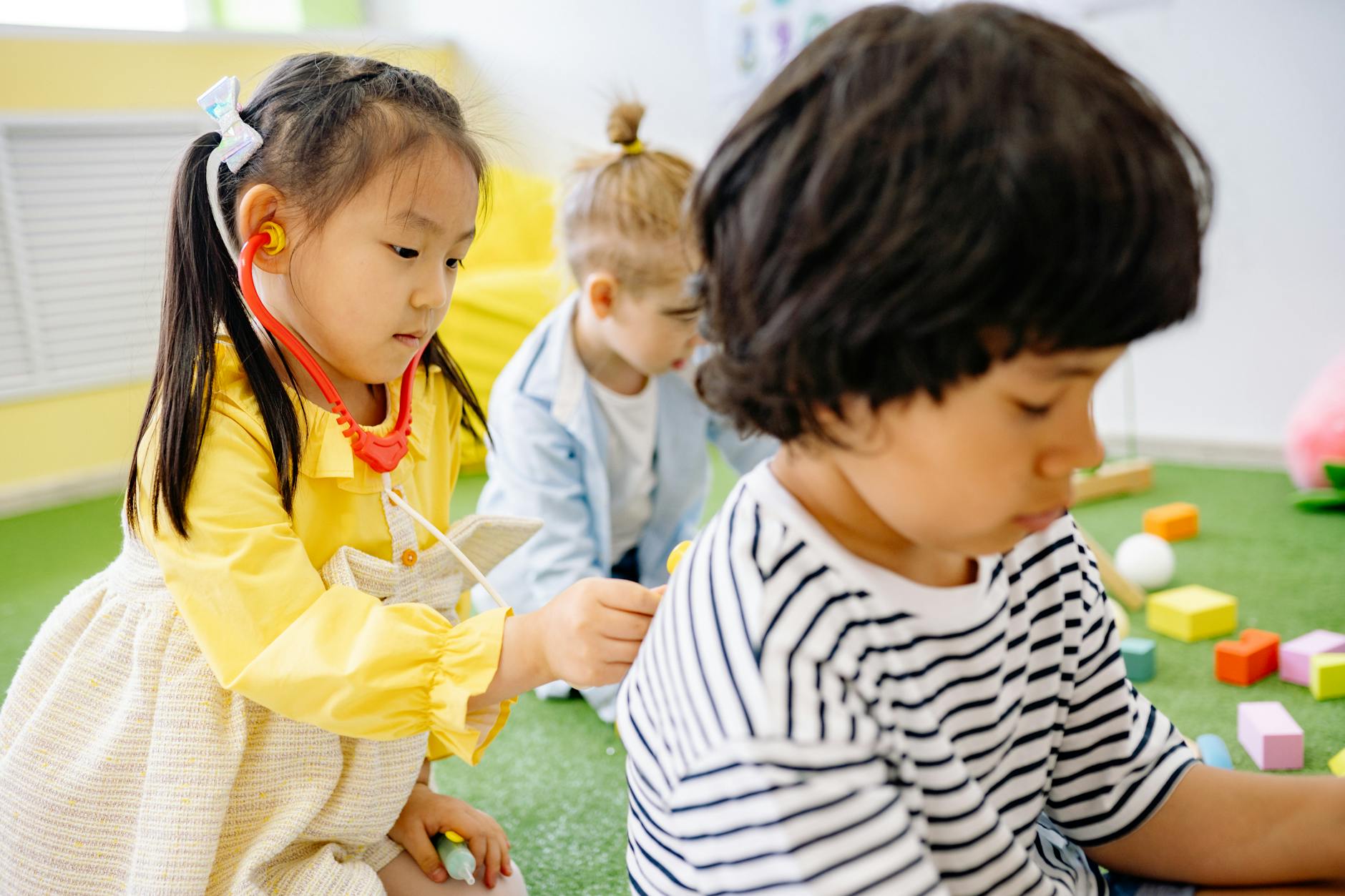 Children engaged in supervised play activities at a modern daycare facility
