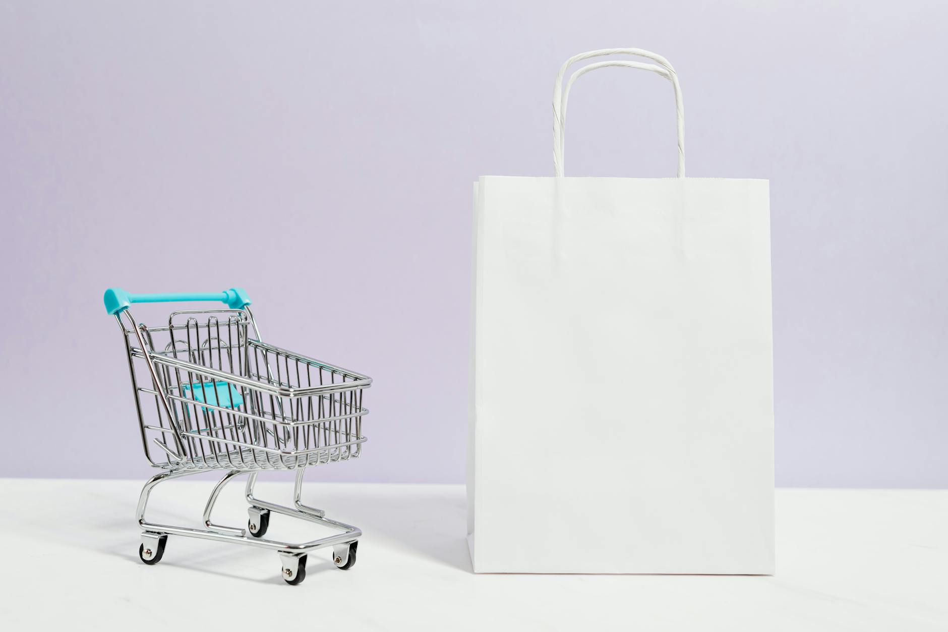 Shopping cart filled with various retail products and groceries in store aisle