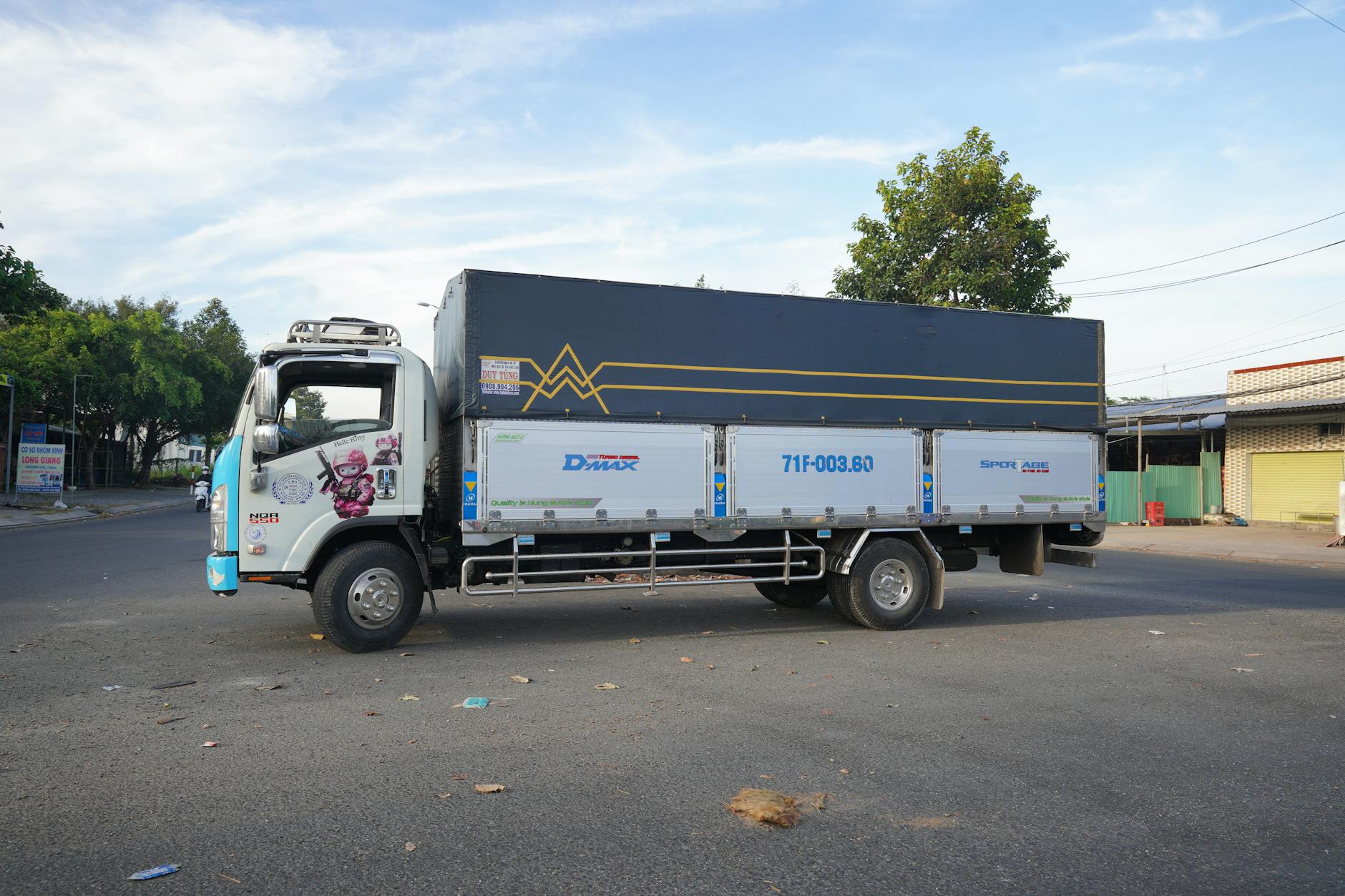 Row of delivery trucks parked at a logistics facility loading dock