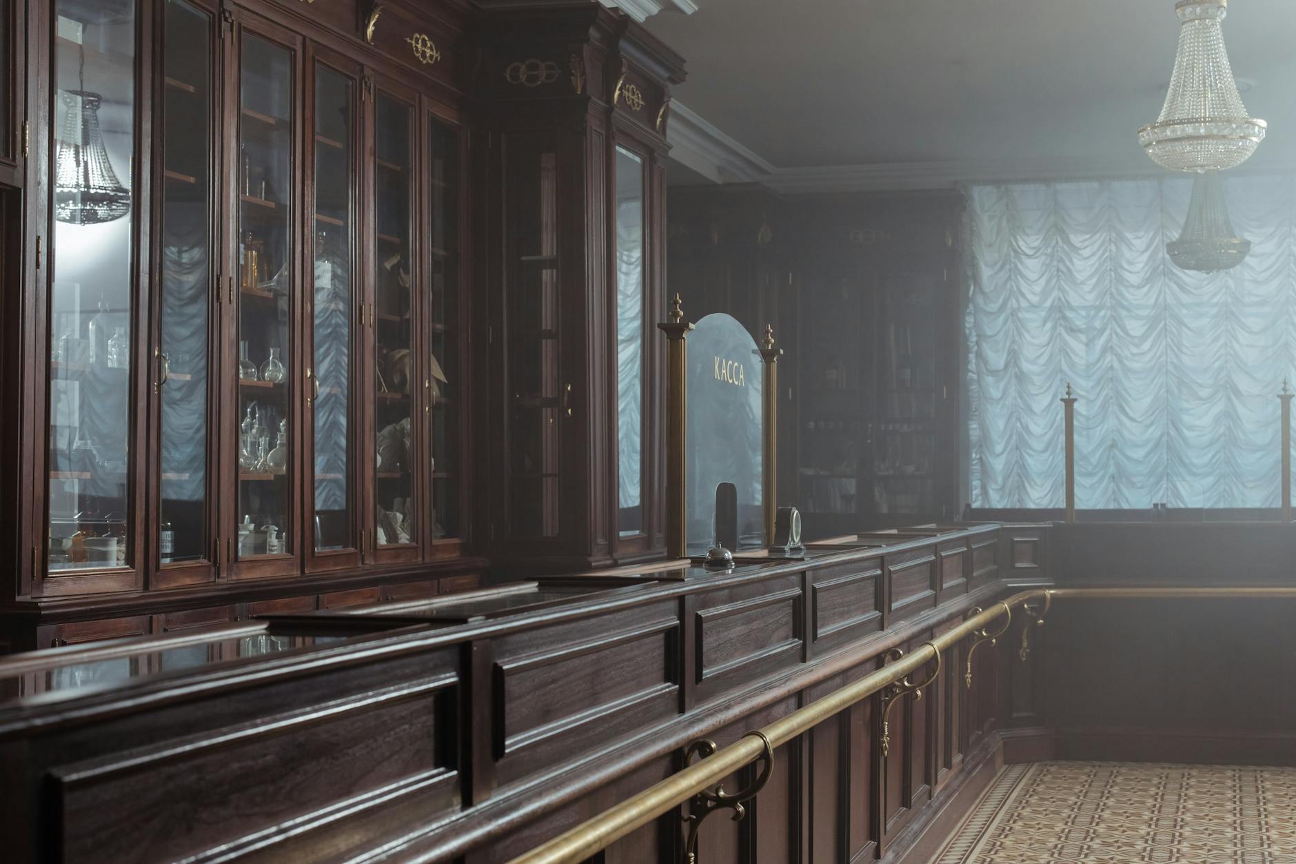 Pharmacy counter with medication shelves and consultation area in retail setting