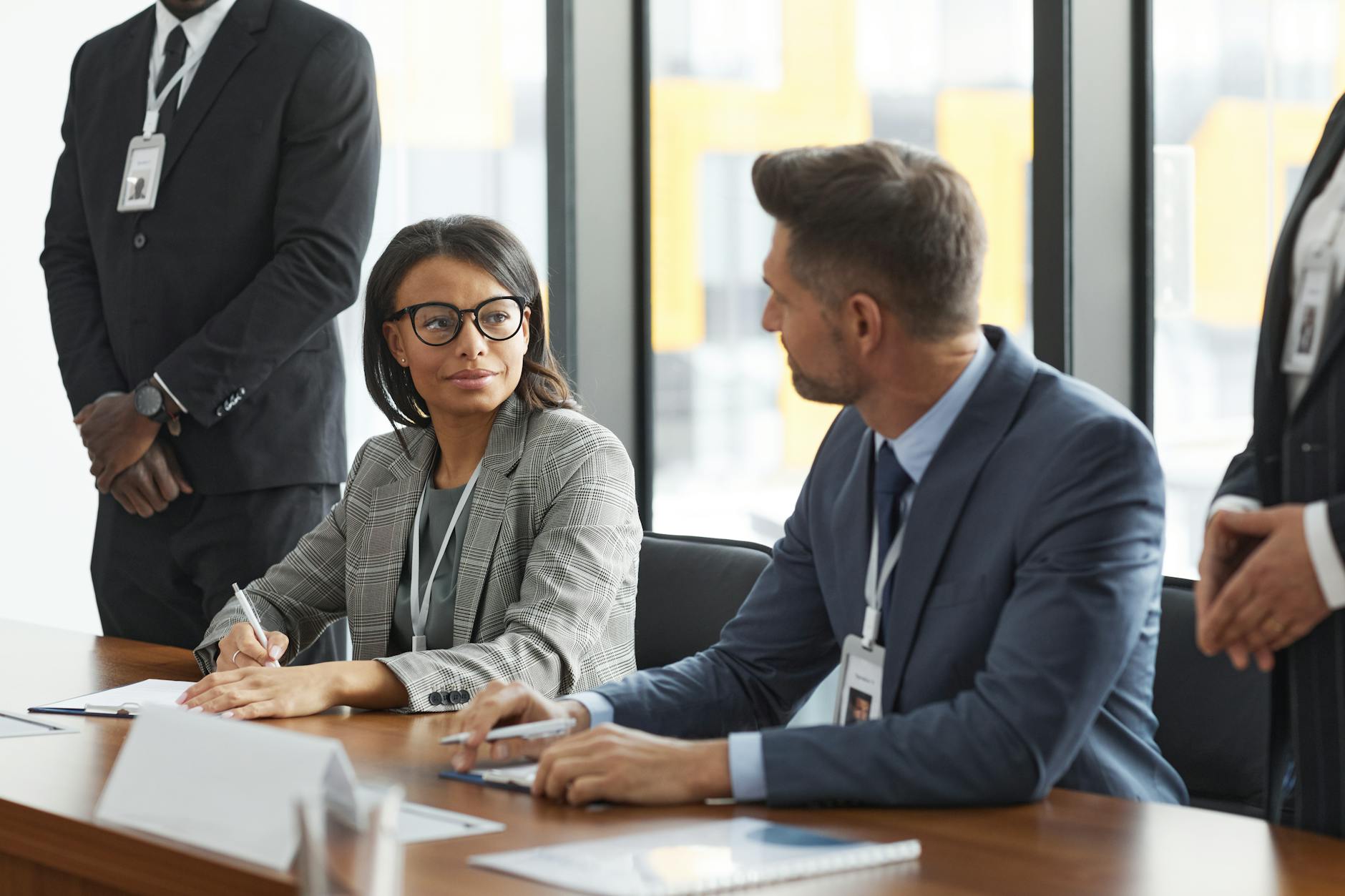 Business professionals discussing strategy around conference table