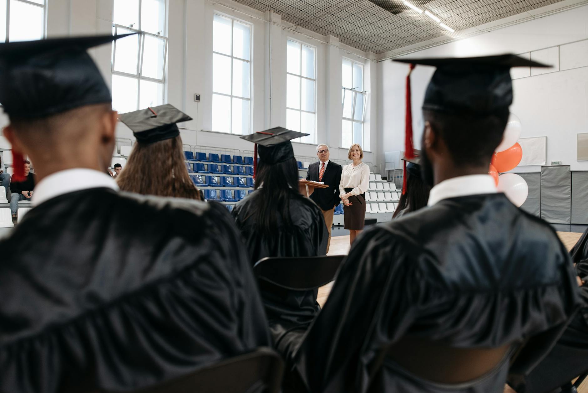 Graduate students in caps and gowns at university graduation ceremony