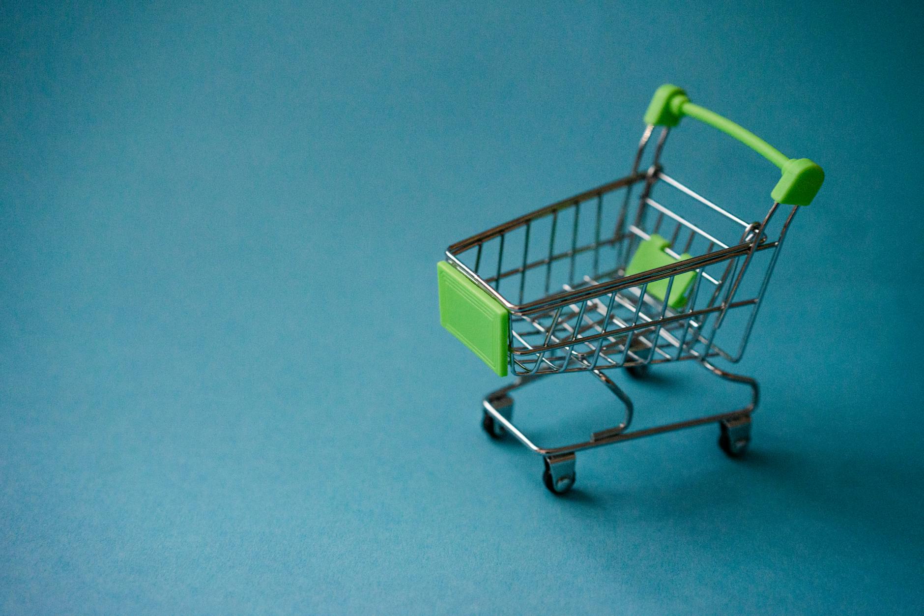 Shopping cart filled with groceries in supermarket aisle