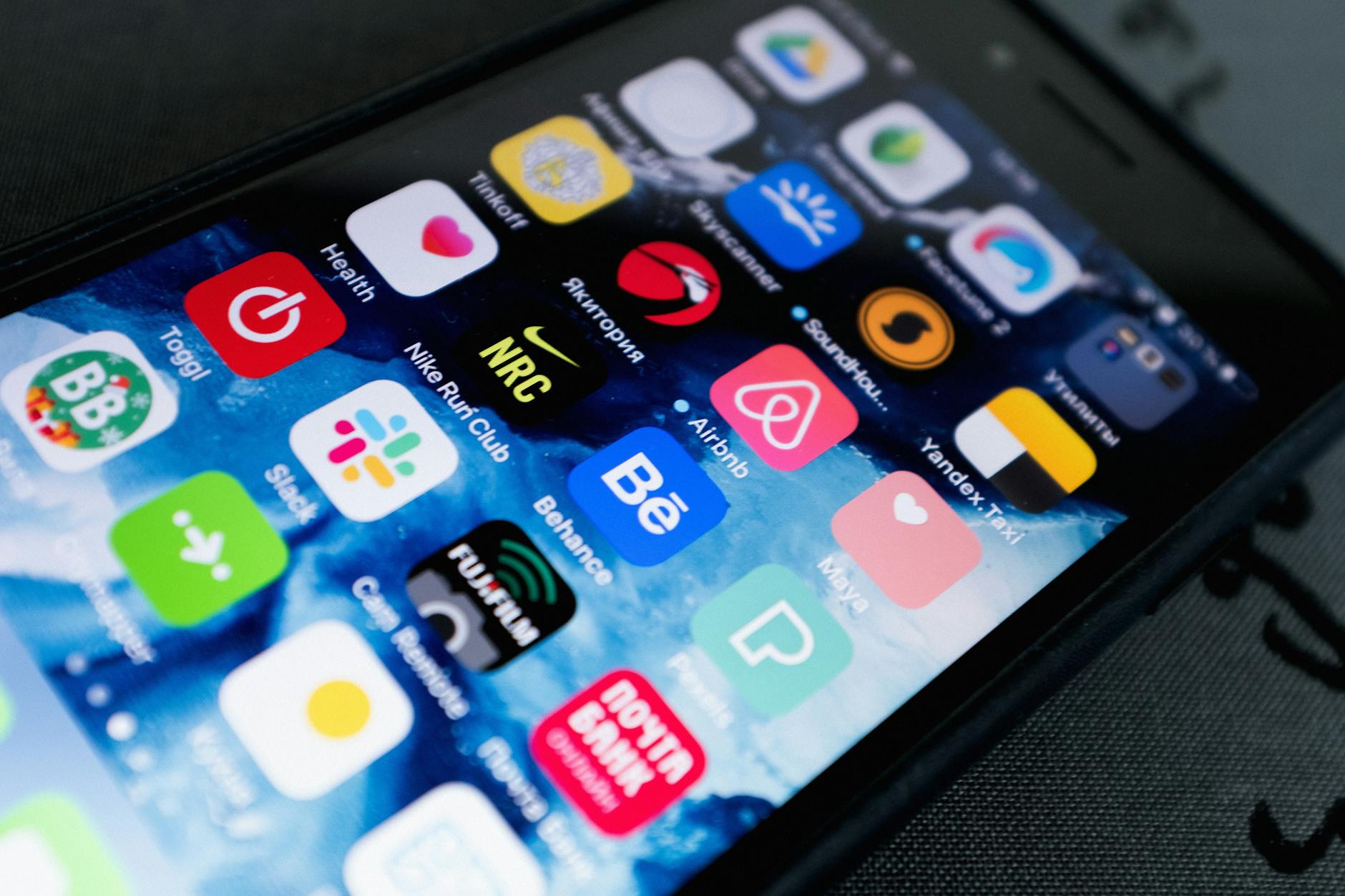 Person using smartphone displaying mobile application interface