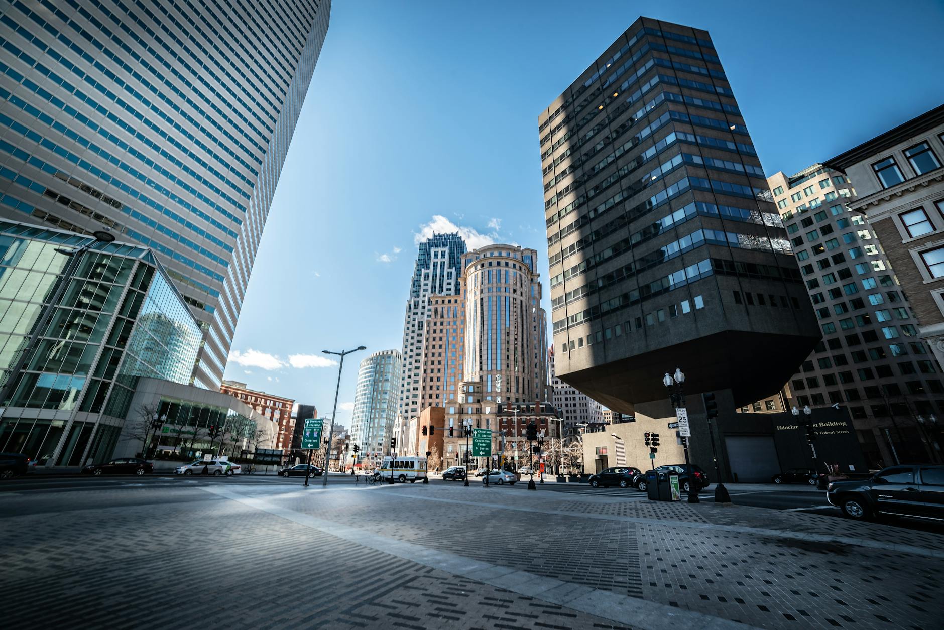 Downtown business district with office buildings and pedestrians on sidewalks
