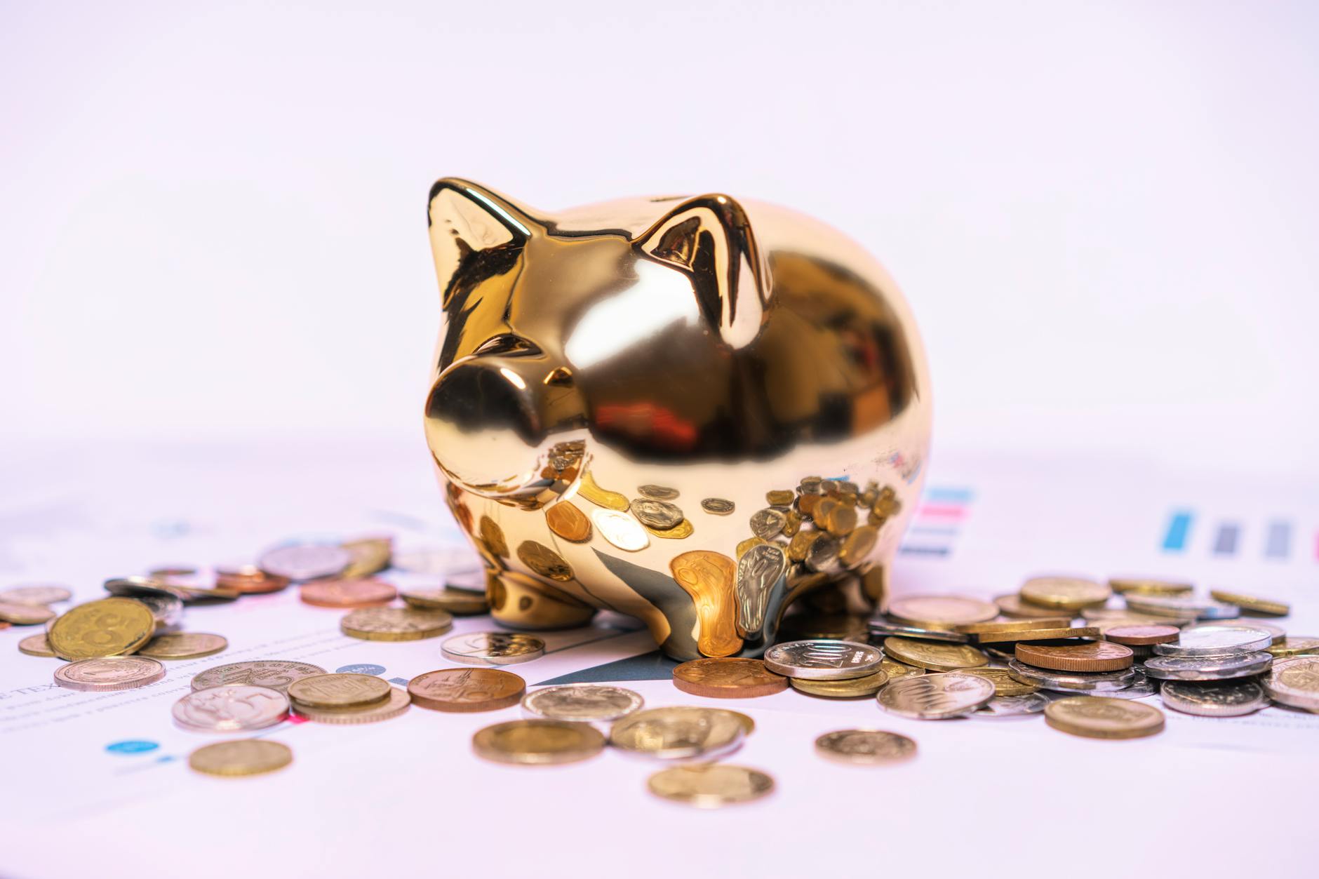 Piggy bank surrounded by coins representing retirement savings growth
