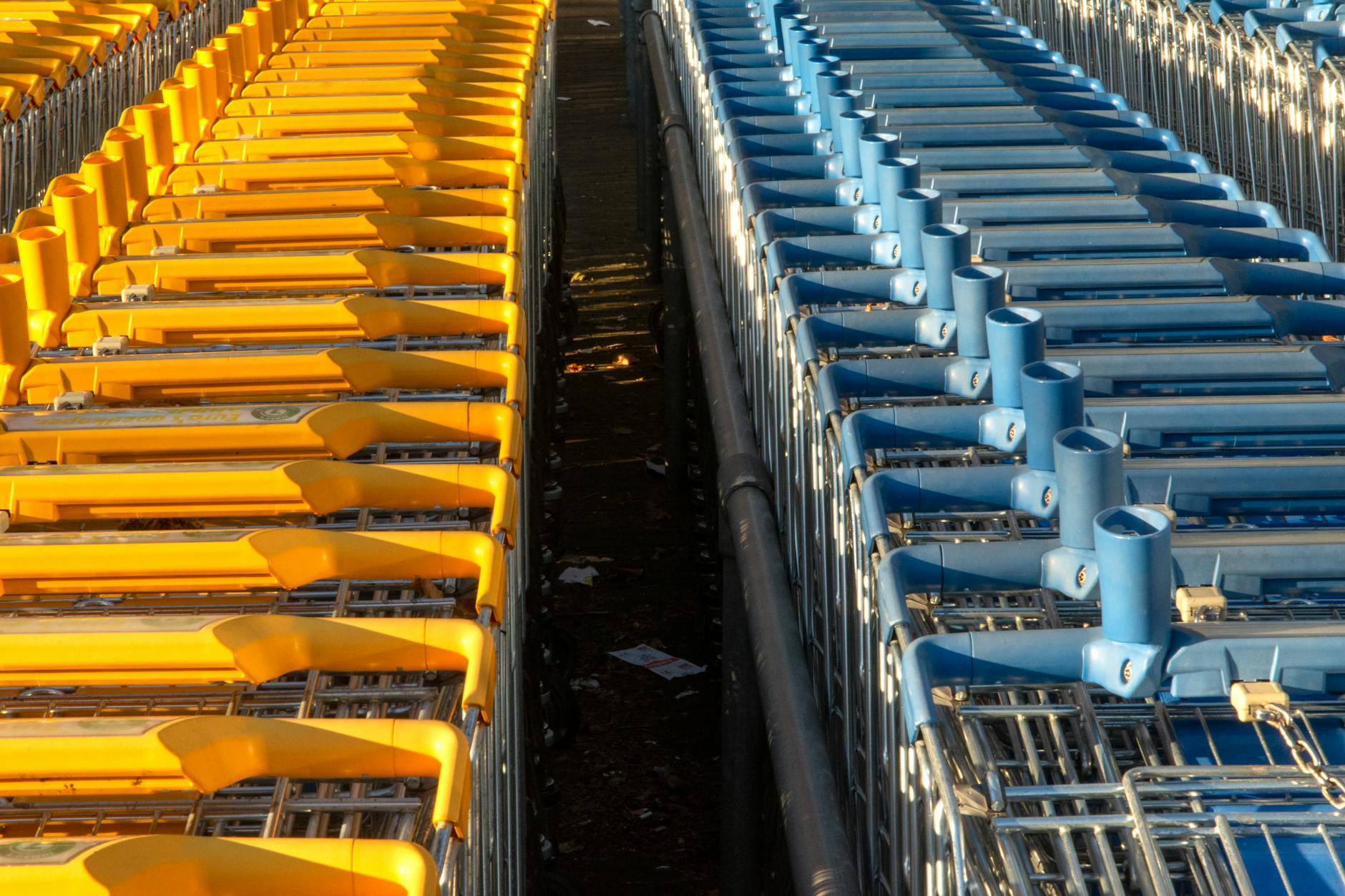 Shopping cart at grocery store checkout counter with payment terminal