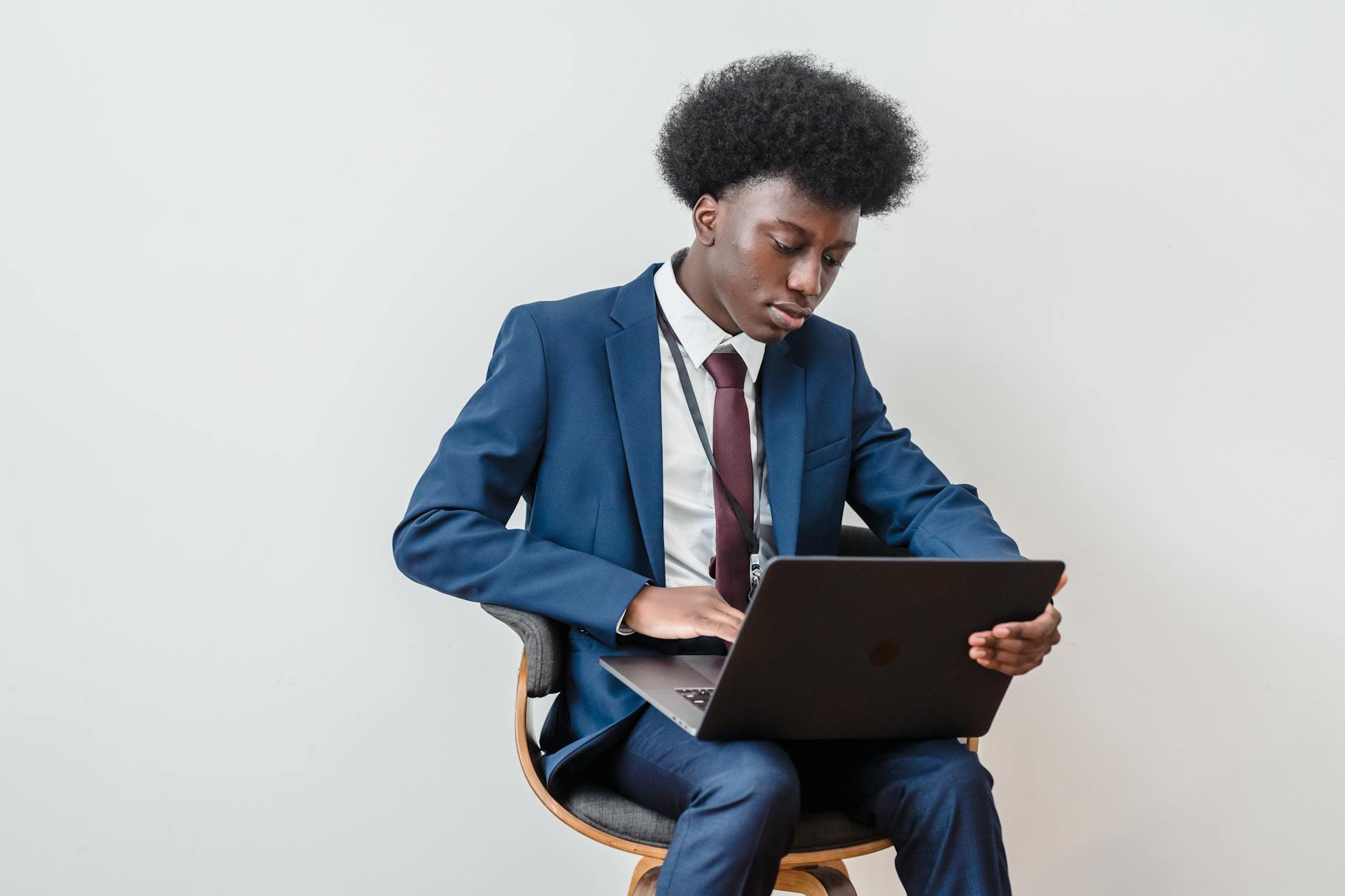 Young professional working on laptop, representing Gen Z investors managing their fractional real estate portfolios