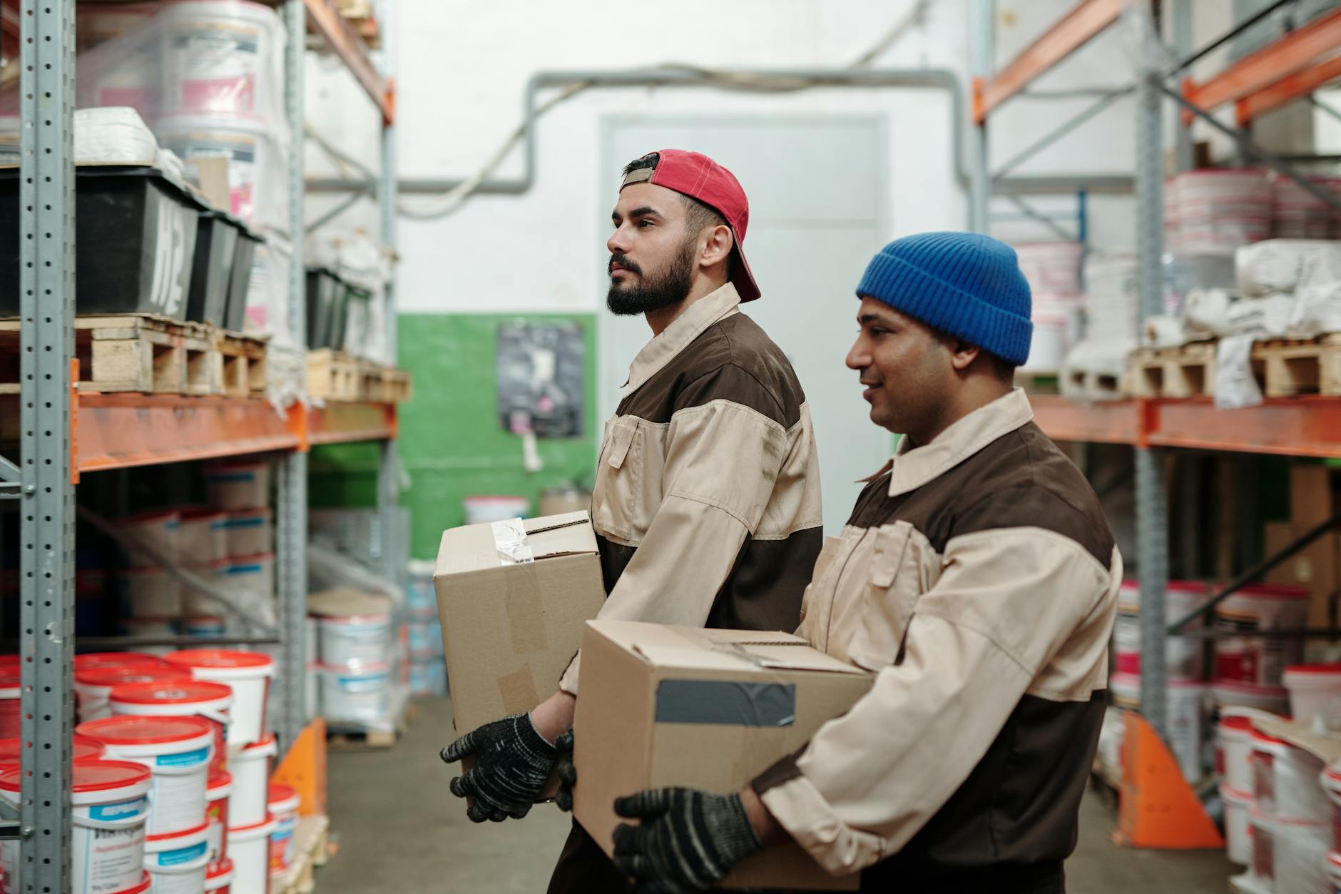 Retail employee in uniform assisting customers at store checkout area
