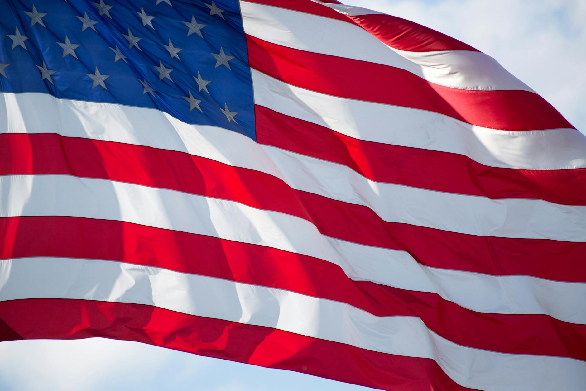 American flag displayed in manufacturing facility with industrial equipment