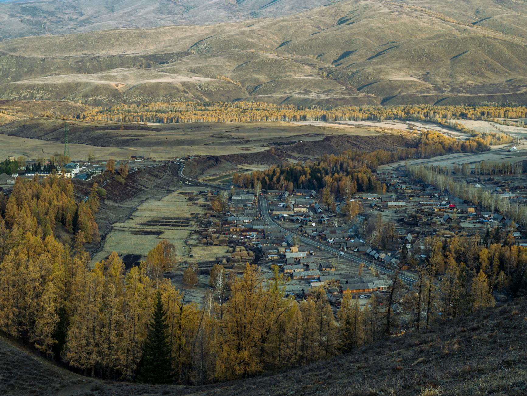 Aerial view of a picturesque mountain town nestled among hills and forests