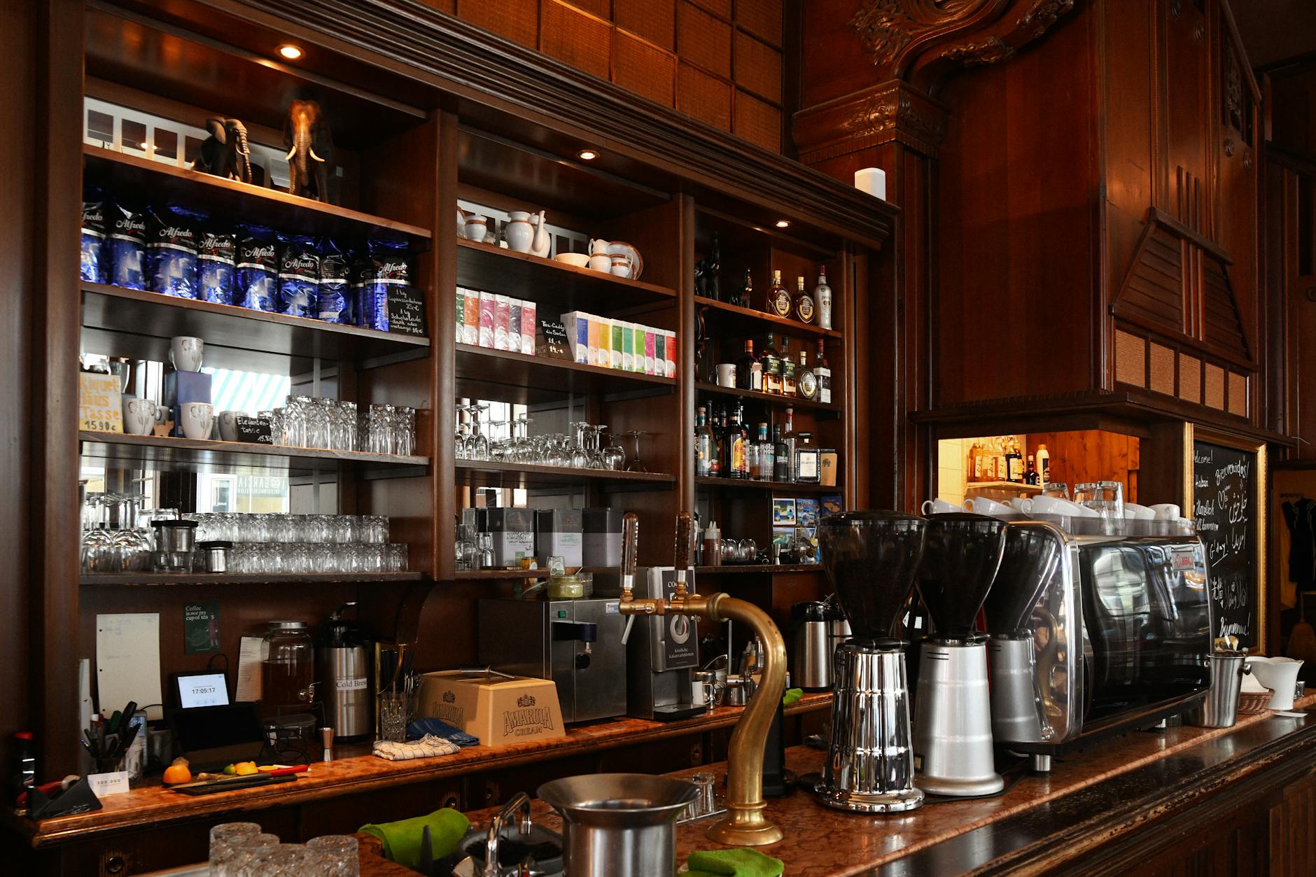 Modern coffee shop interior with customers using mobile devices, showing digital transformation in retail