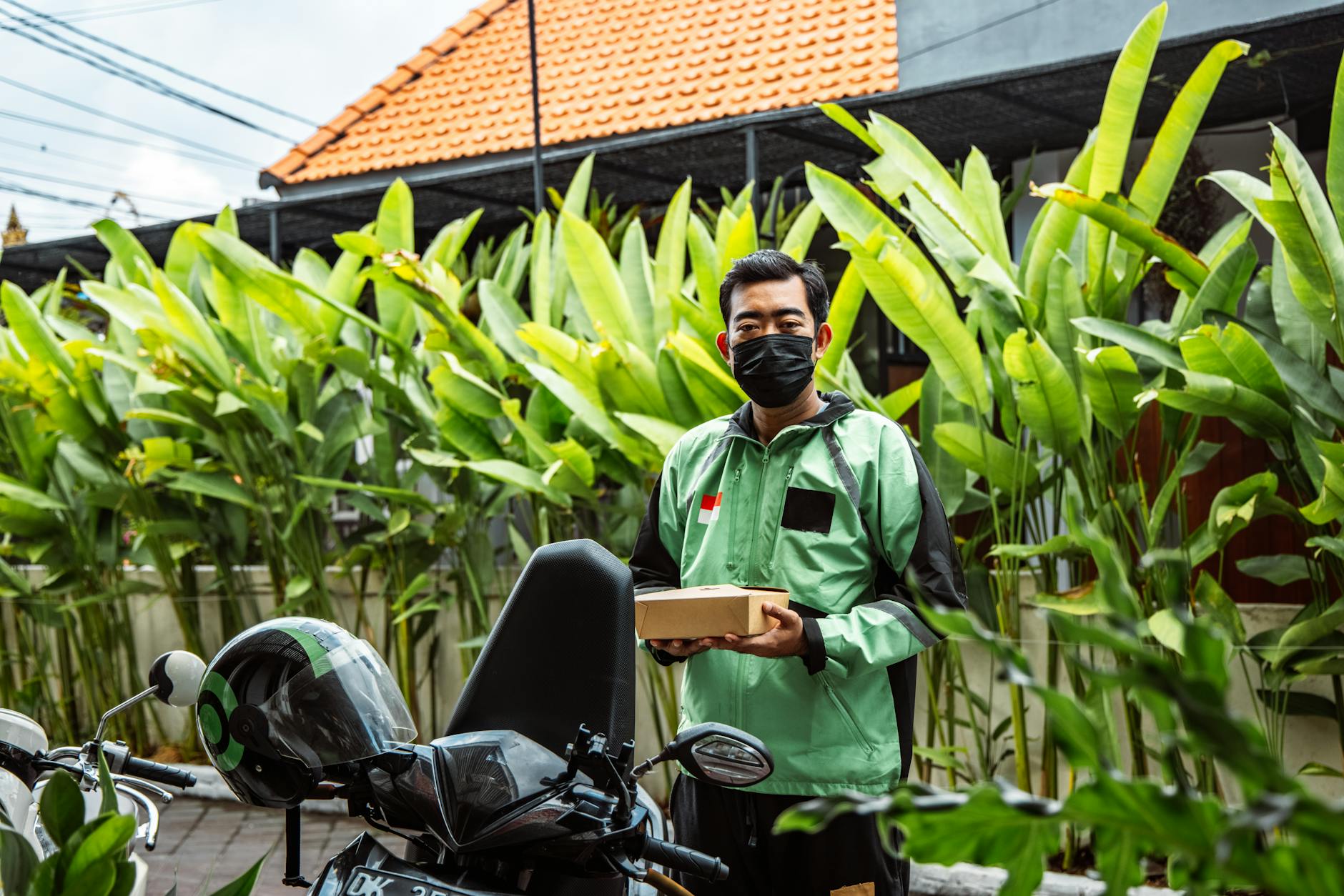 Food delivery driver with insulated bag preparing for delivery pickup