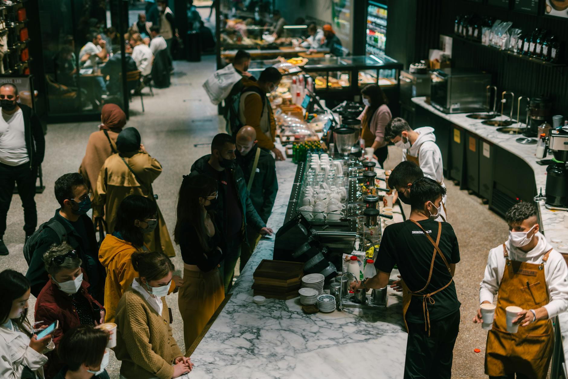 Crowded fast casual restaurant dining area with customers eating