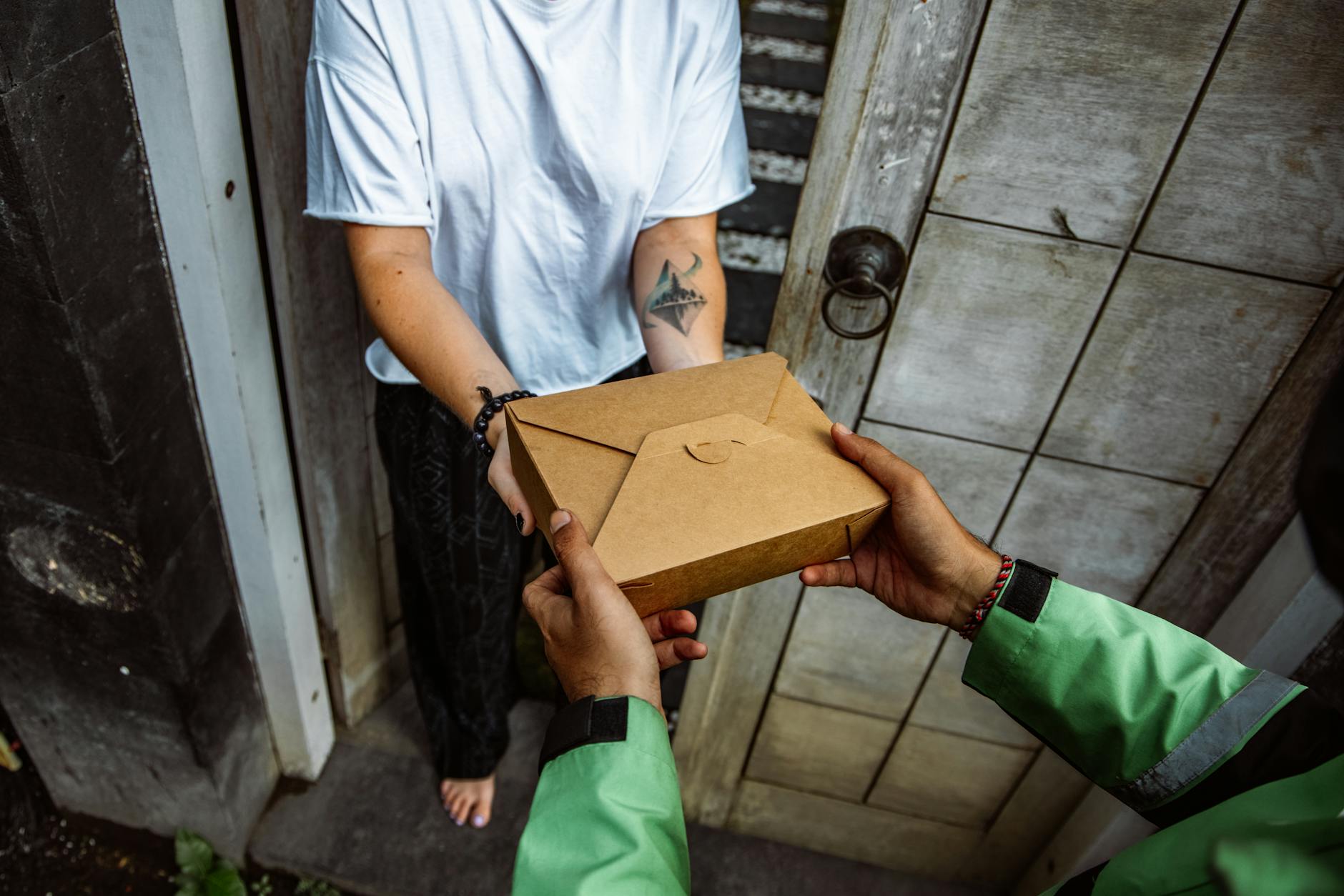 Person holding a subscription box package ready for delivery