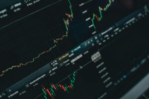 Stock market trading floor with electronic displays showing rising prices