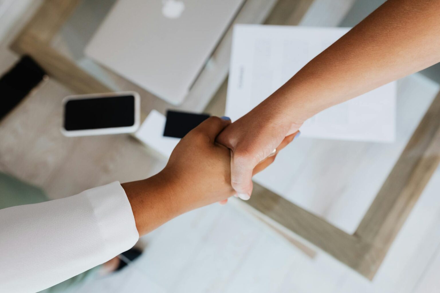 Alphabet Commits $10 Billion to Anthropic with $30 Billion More Pending Business professionals shaking hands over investment agreement