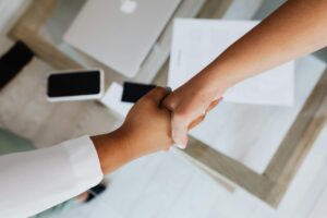 Business professionals shaking hands over investment agreement