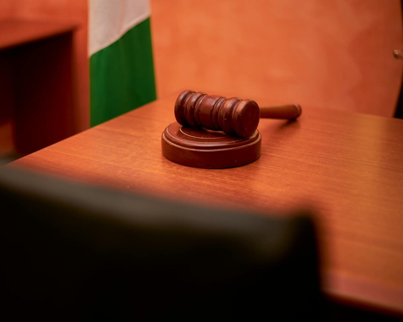 Rap Lyrics as Evidence Create Costly Legal Precedent Wooden gavel on judge's bench in empty courtroom